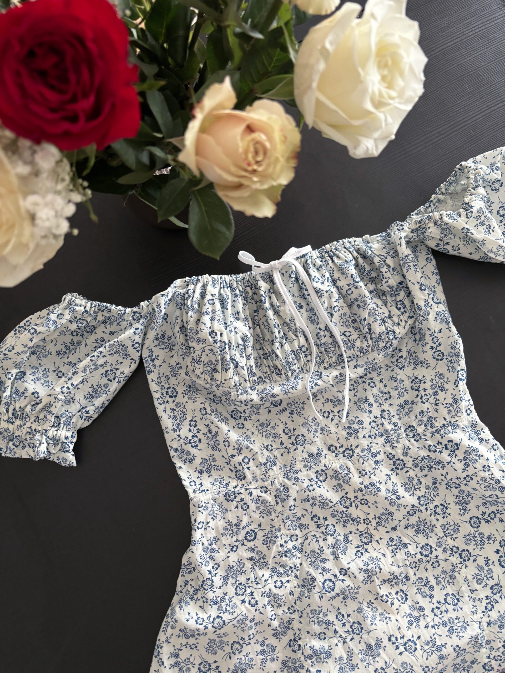 A sweet cottagecore dress with ditsy floral print and a bow knot.