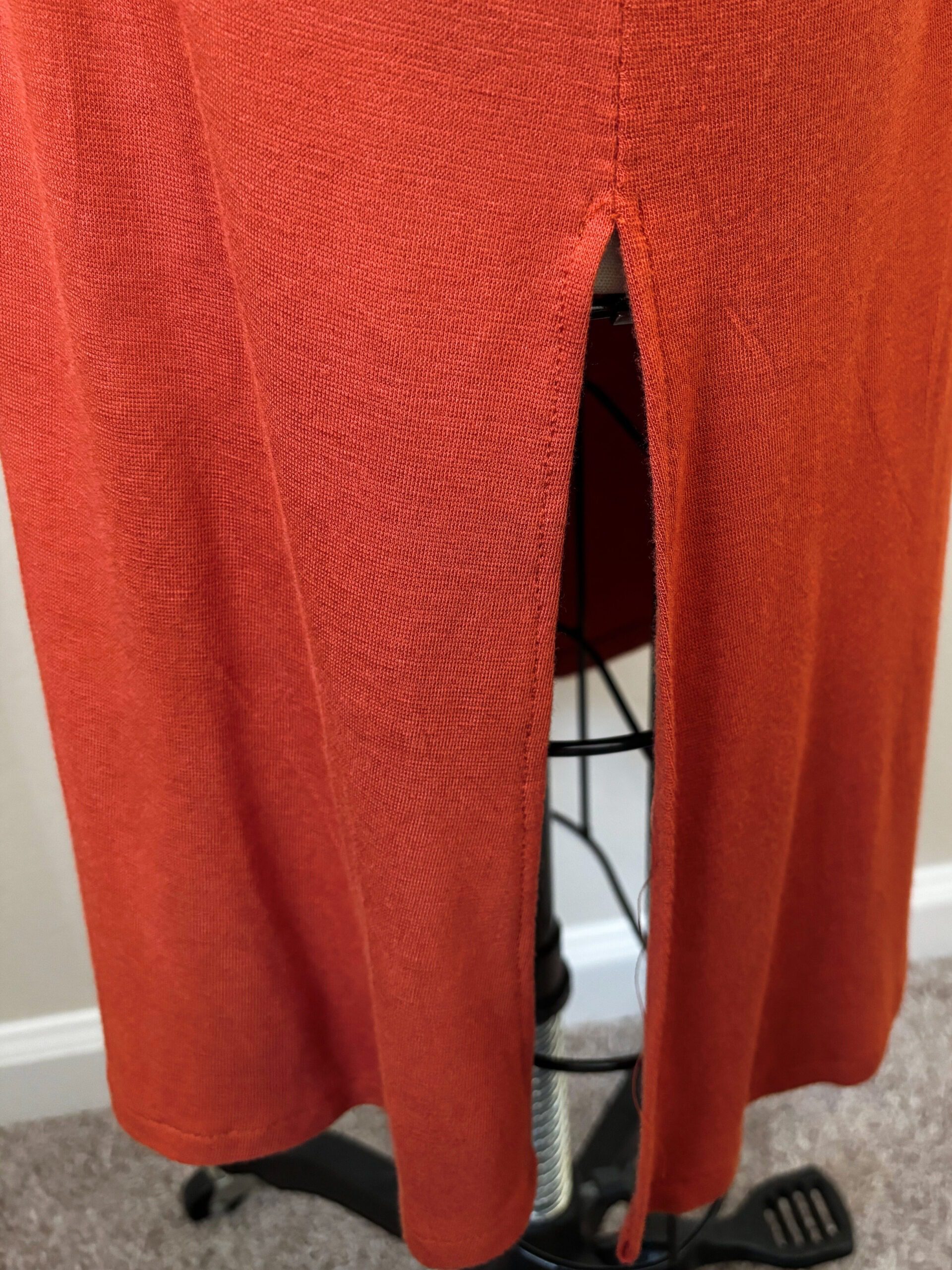 A close up look on the leg slit, bottom part of the knit dress.