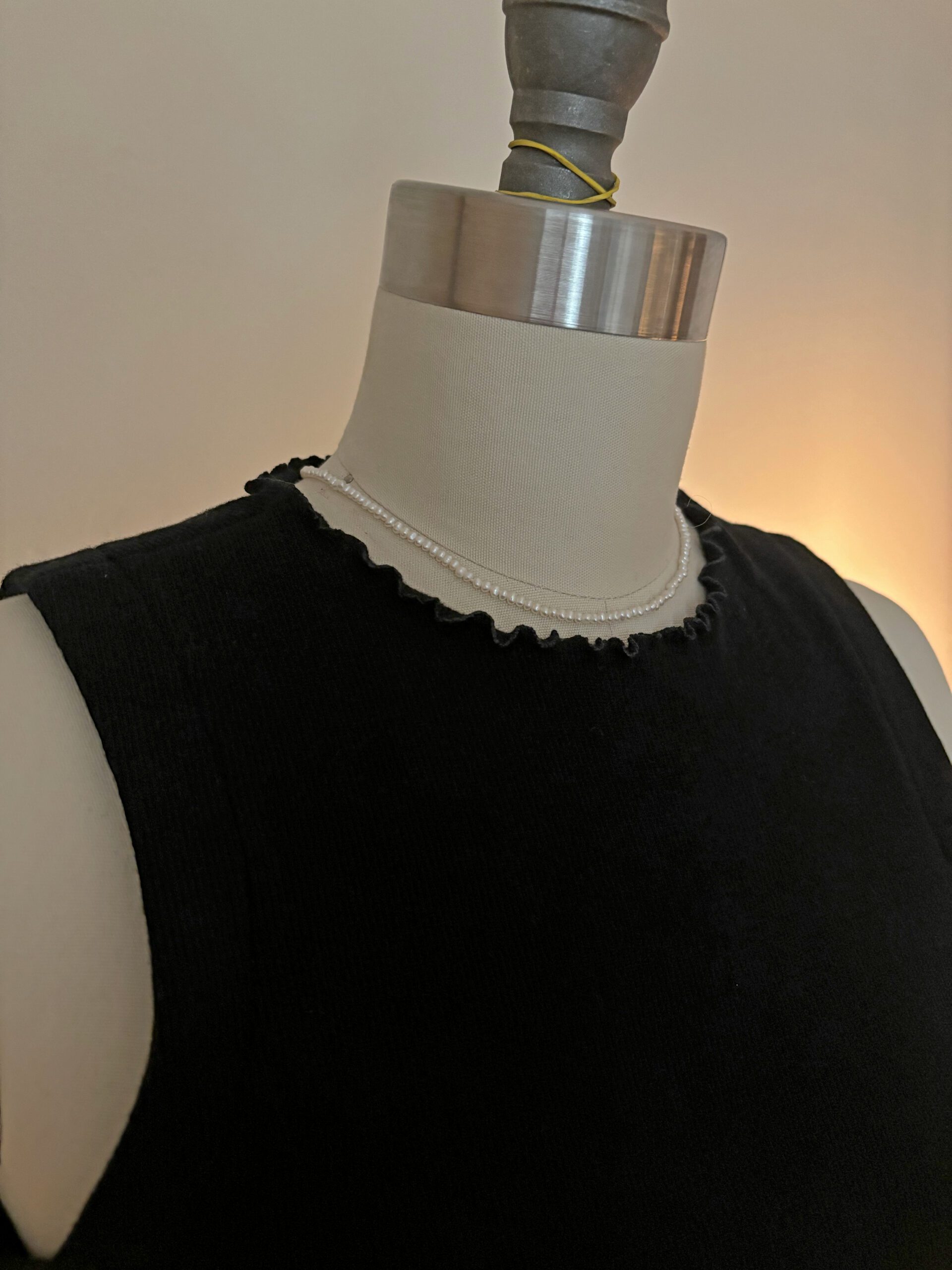 A close up look on the lettuce hem detail on the neckline