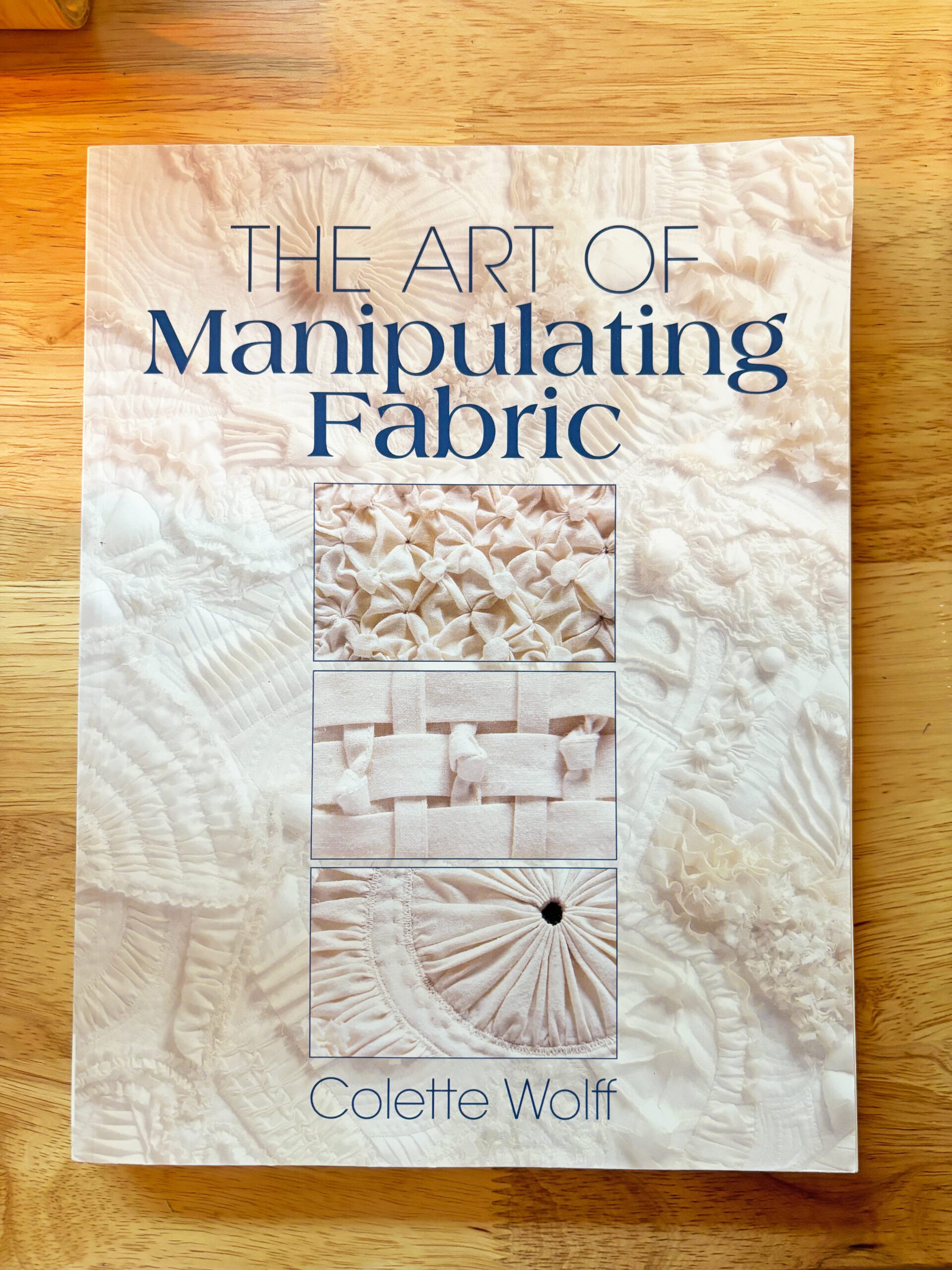 A book titled The Art of Manipulating Fabric containing many fabric dimensional techniques from gathering to smocking.