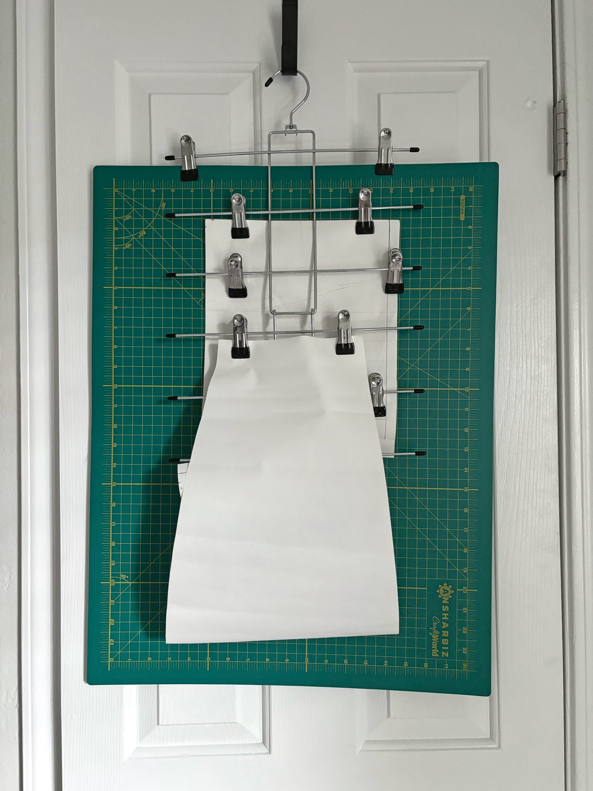 A 6 tier closet organizers with clips to hang your pattern pieces and cutting mats.