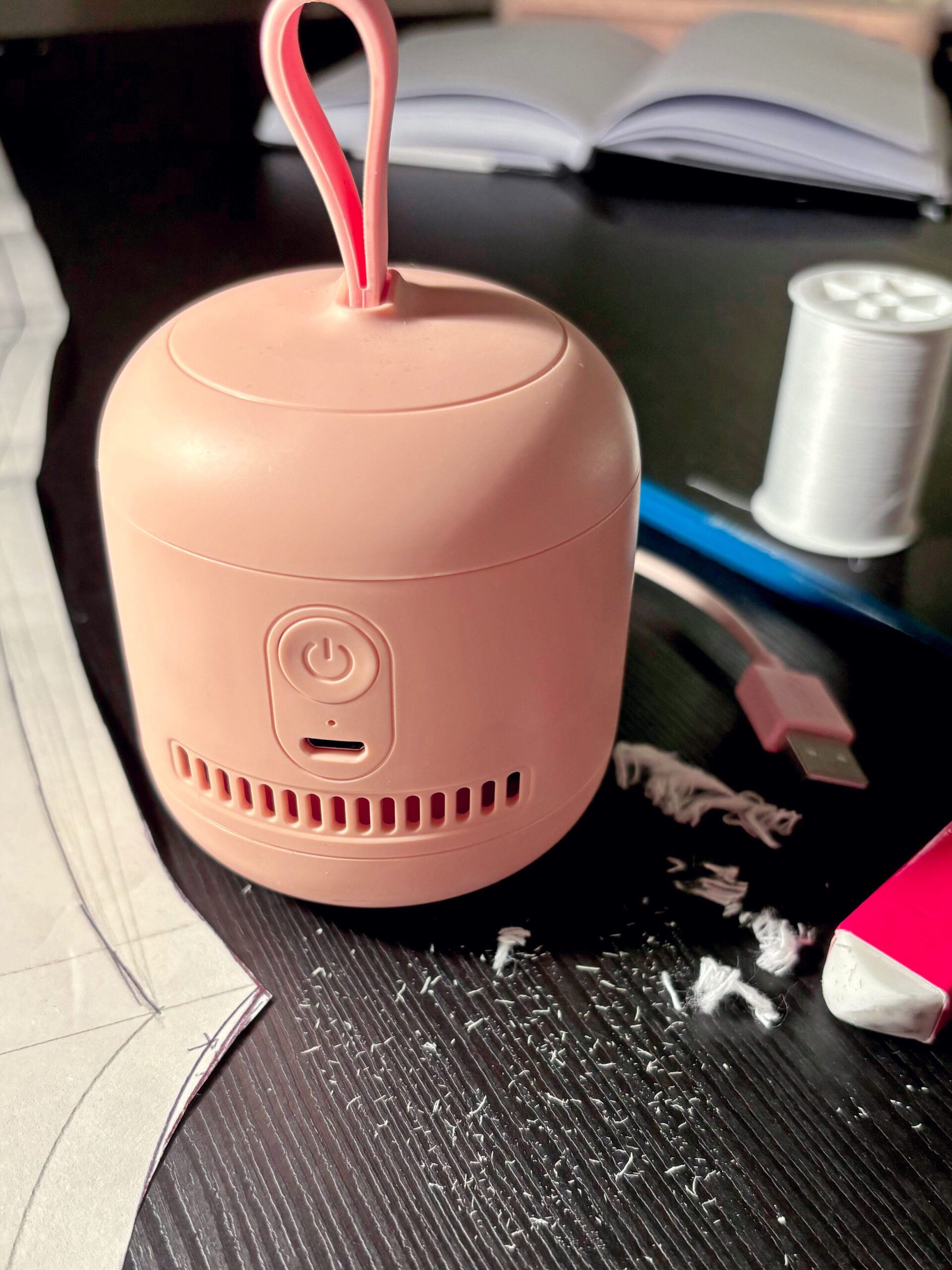 A mini rechargable desk vacuum cleaner that is good for cleaning eraser dusts and thread pieces.