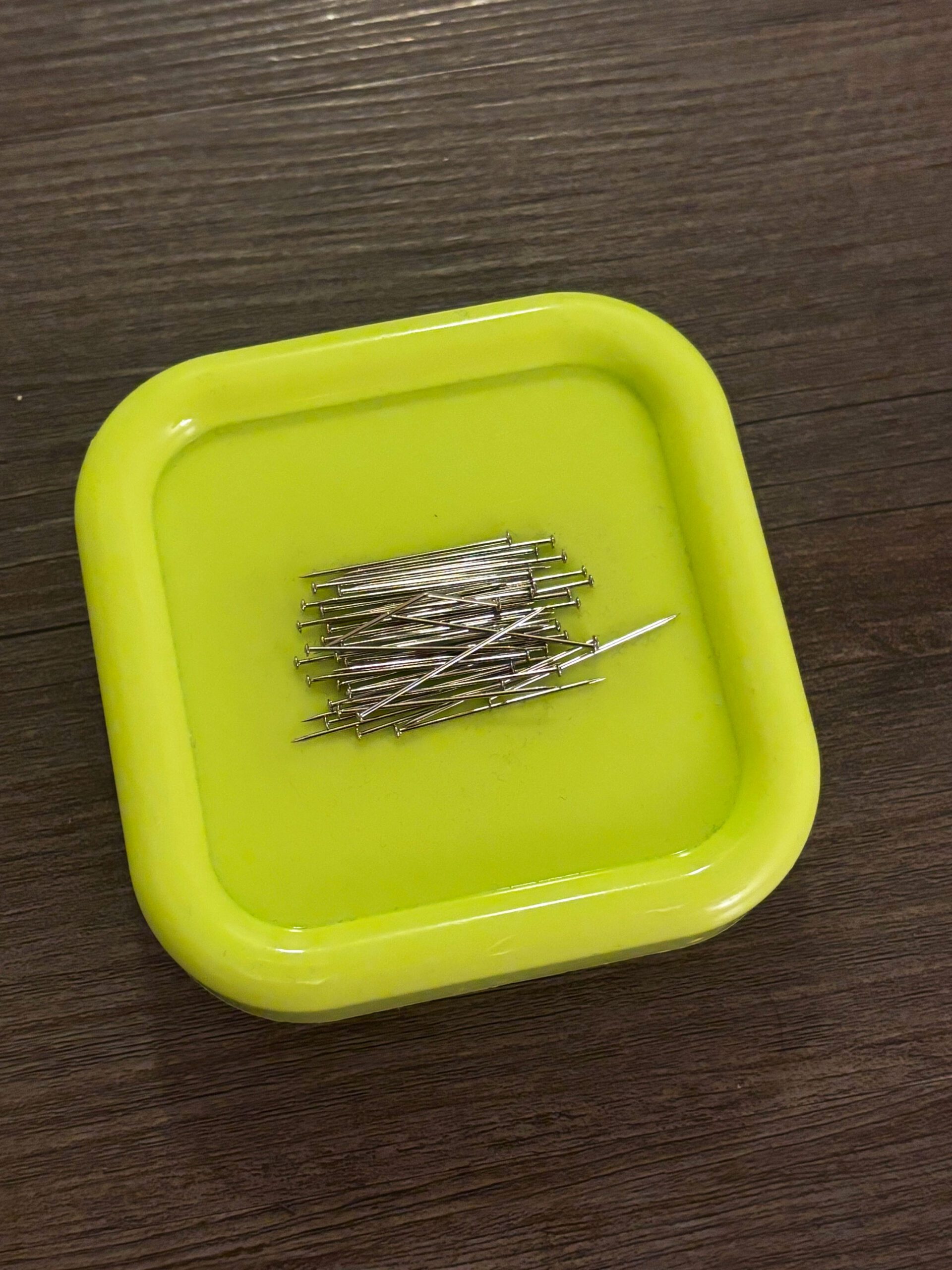 A neon colored magnetic pin cushion to hold your sewing pins in place.