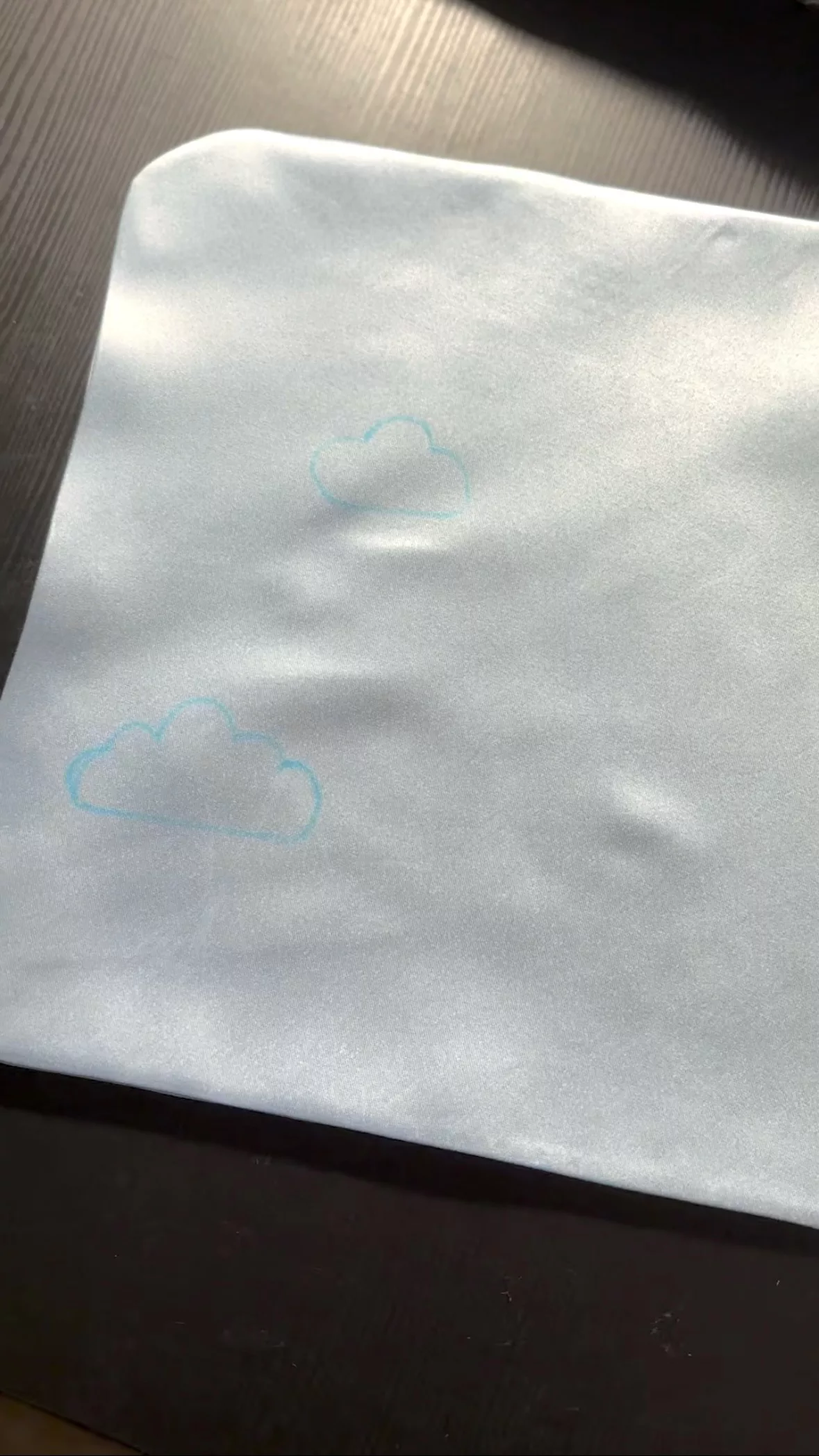 A close-up view of the drawn cloud design on the main fabric.