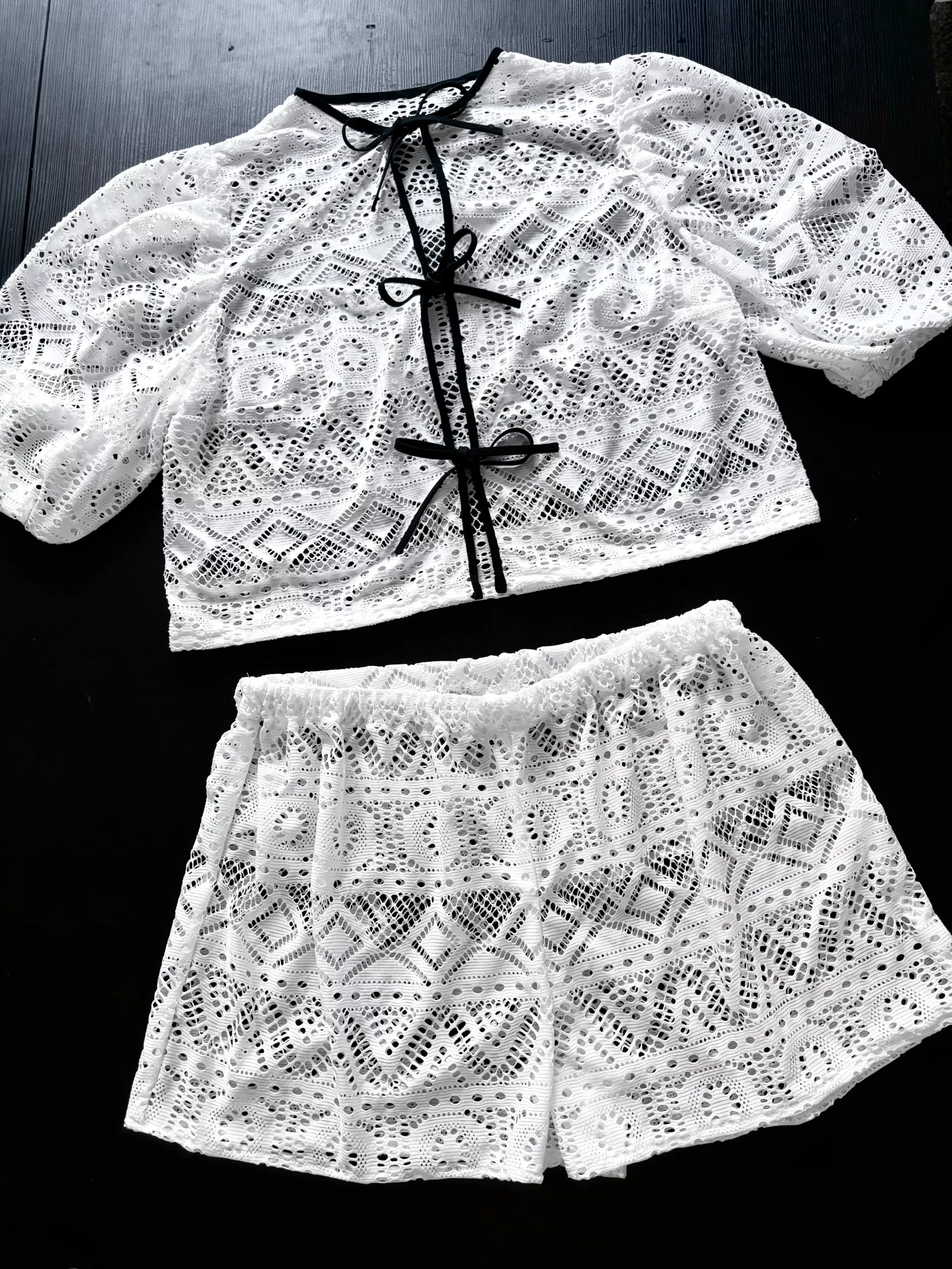 A full view of the open-knit cardigan and shorts set.